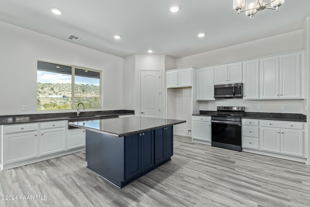 kitchen with light wood-type flooring, white cabinetry, sink, and appliances with stainless steel finishes