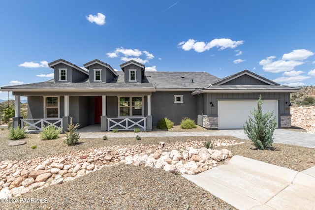 view of front of house featuring a porch and a garage