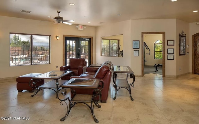 living room featuring french doors and ceiling fan