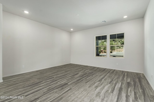 unfurnished room with hardwood / wood-style flooring