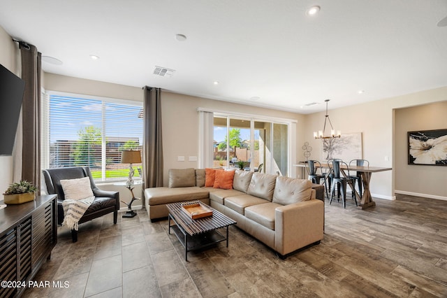 living room featuring hardwood / wood-style floors and a notable chandelier