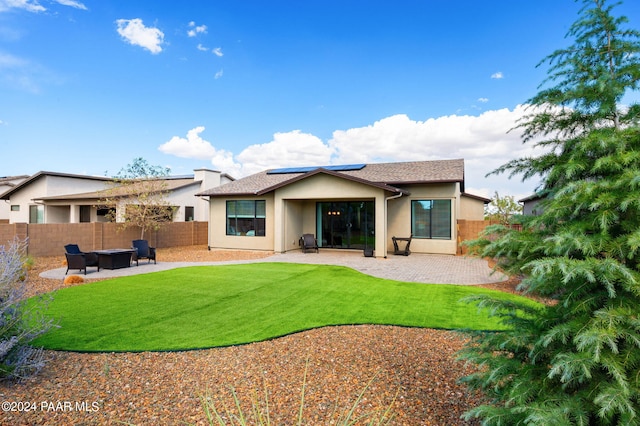 back of property with outdoor lounge area and a patio