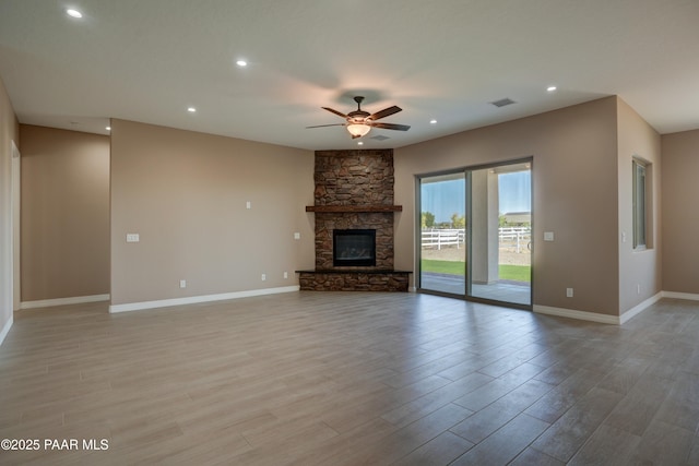 1438 W Anne Marie Dr, Chino Valley, AZ 86323 - unfurnished living room with ceiling fan, light wood-style floors, a fireplace, and recessed lighting