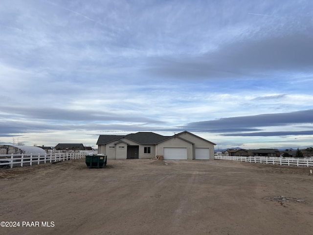 view of front of property featuring a rural view and a garage