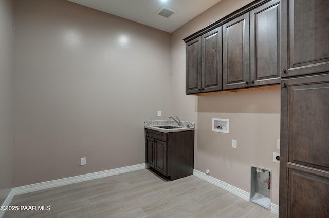 1438 W Anne Marie Dr, Chino Valley, AZ 86323 - laundry room featuring cabinet space, hookup for an electric dryer, light wood finished floors, washer hookup, and gas dryer hookup