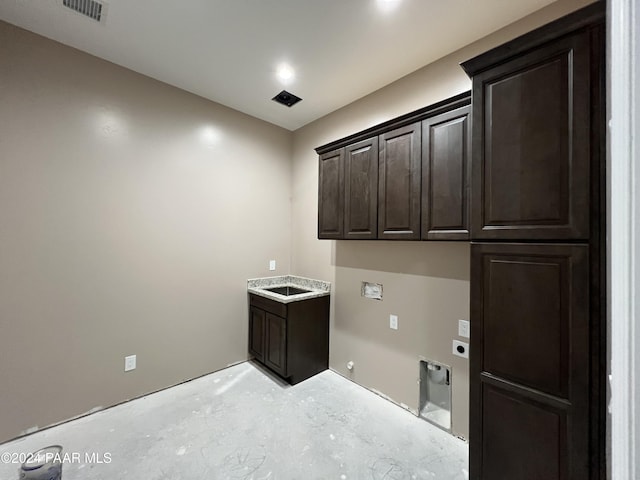 clothes washing area featuring hookup for a gas dryer, cabinets, and hookup for an electric dryer