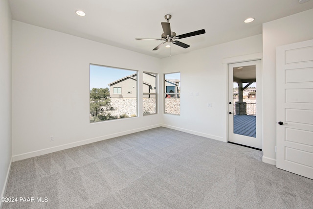 spare room featuring baseboards, carpet flooring, recessed lighting, and plenty of natural light