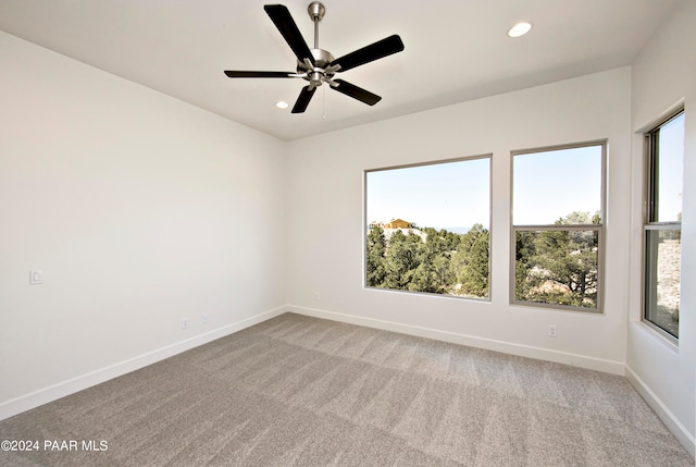 empty room with baseboards, carpet floors, and recessed lighting