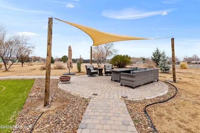 view of patio featuring an outdoor living space with a fire pit