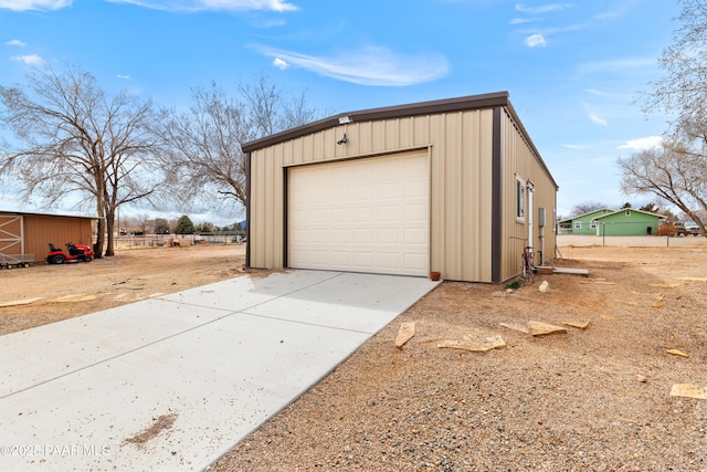 detached garage with concrete driveway