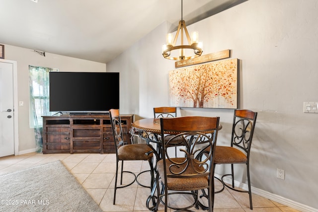dining space featuring tile patterned flooring, vaulted ceiling, baseboards, and a chandelier