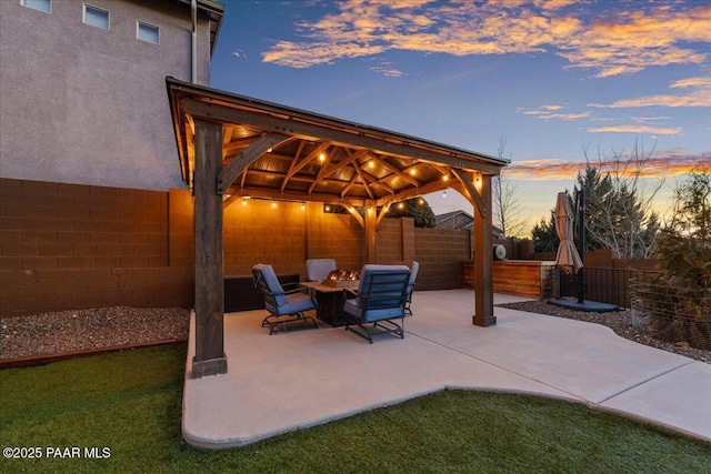 patio terrace at dusk featuring a gazebo