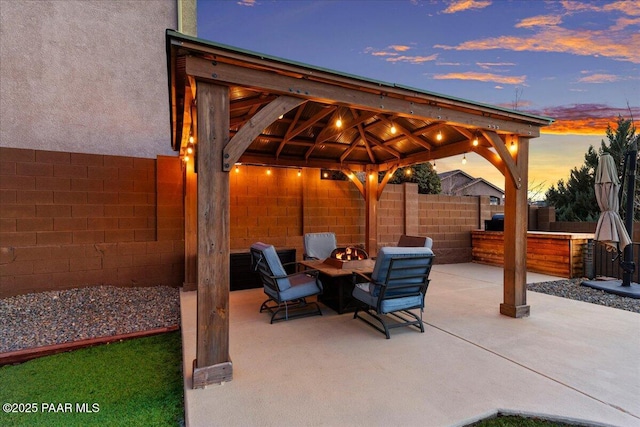 patio terrace at dusk with a gazebo and an outdoor hangout area