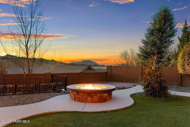 yard at dusk featuring a fire pit