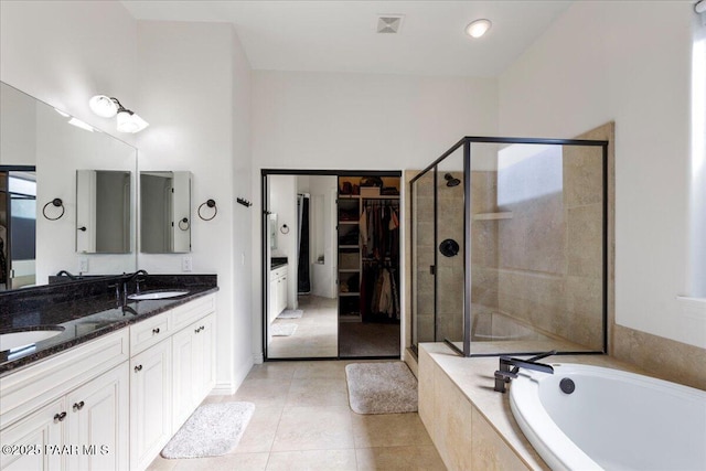 bathroom with shower with separate bathtub, tile patterned floors, and vanity