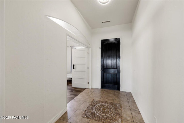 foyer entrance with tile patterned flooring