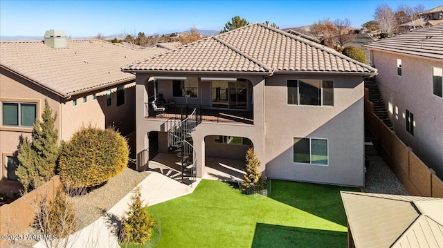 rear view of property with a yard and a patio area