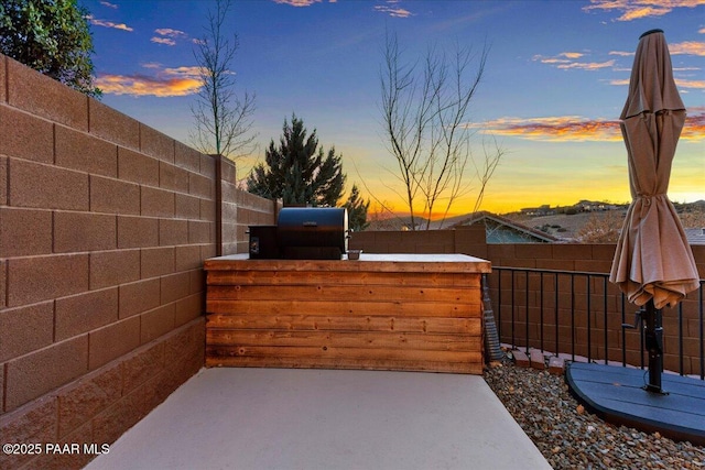 patio terrace at dusk with area for grilling