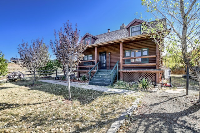 log-style house with a front lawn and a porch