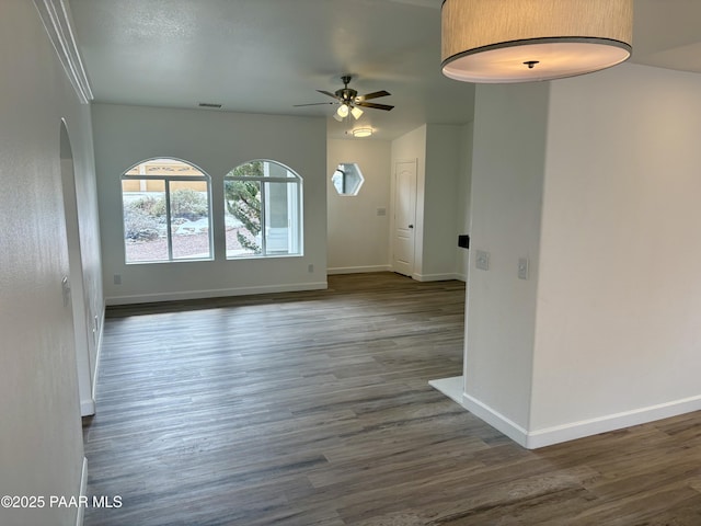 spare room with dark hardwood / wood-style floors and ceiling fan