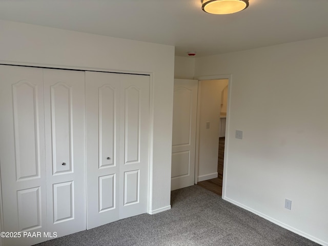 unfurnished bedroom with carpet and a closet