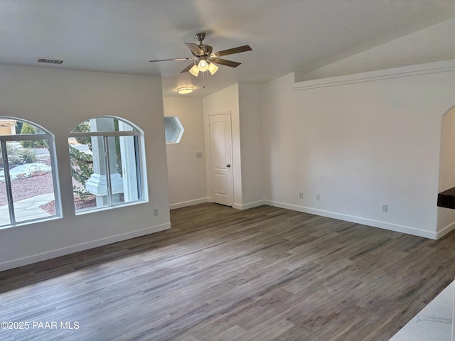 unfurnished living room with ceiling fan and dark hardwood / wood-style flooring