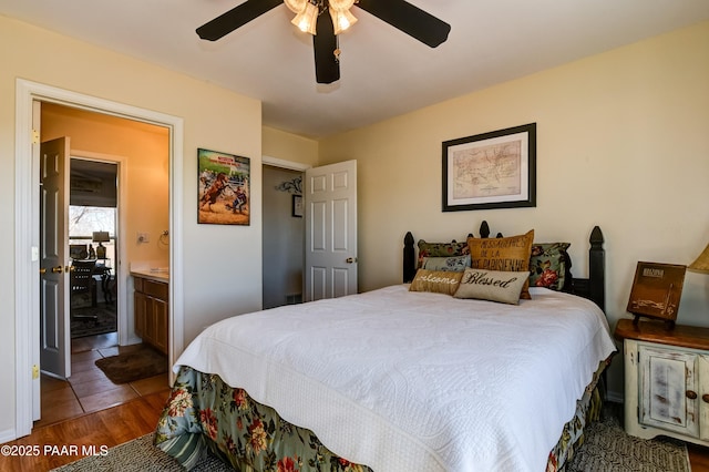 bedroom featuring ceiling fan, wood finished floors, and ensuite bathroom