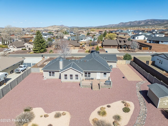 birds eye view of property with a mountain view and a residential view