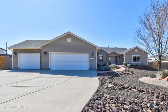 ranch-style home with driveway, a garage, and fence