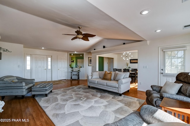 living area with vaulted ceiling, wood finished floors, visible vents, and a wealth of natural light