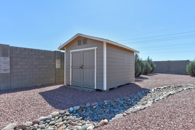 view of shed with a fenced backyard