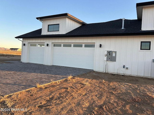 view of garage at dusk