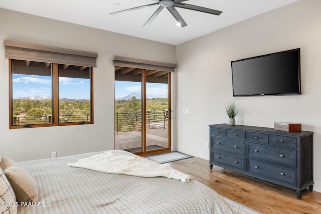 bedroom with access to outside, a ceiling fan, light wood-type flooring, and baseboards