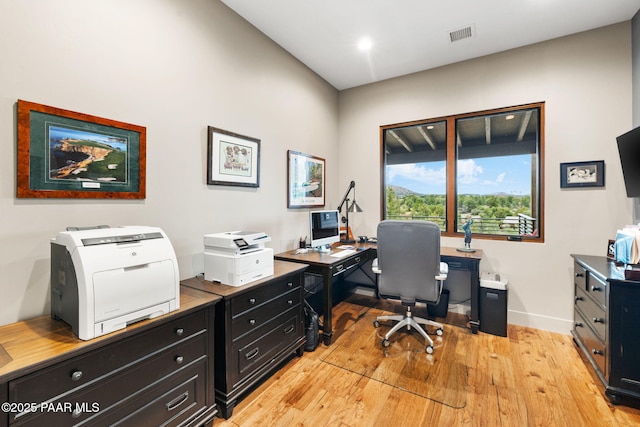 office space featuring visible vents, baseboards, and light wood finished floors