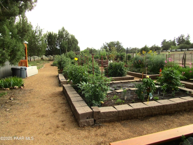 view of yard featuring a vegetable garden and fence