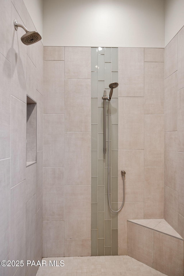 bathroom with a tile shower