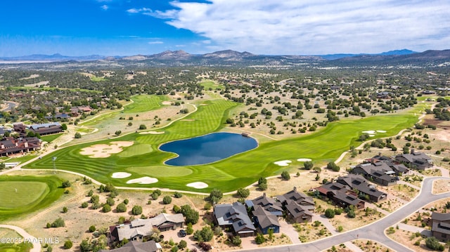 drone / aerial view with a residential view, a water and mountain view, and view of golf course