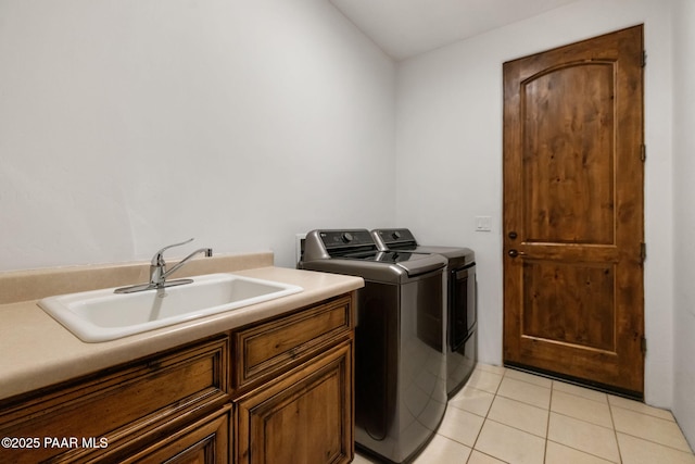 laundry area featuring cabinets, sink, light tile patterned floors, and independent washer and dryer