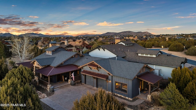 aerial view at dusk featuring a mountain view