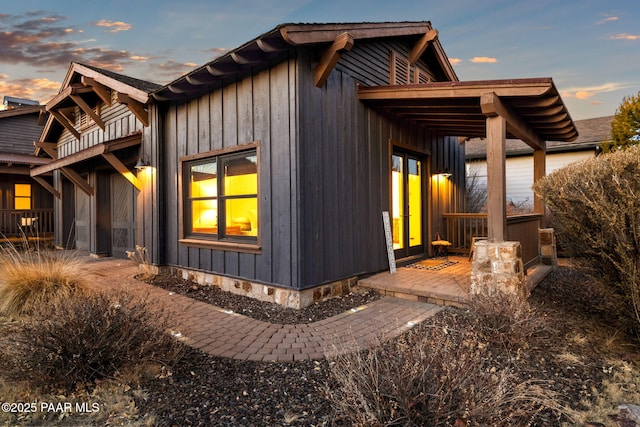 property exterior at dusk featuring a patio