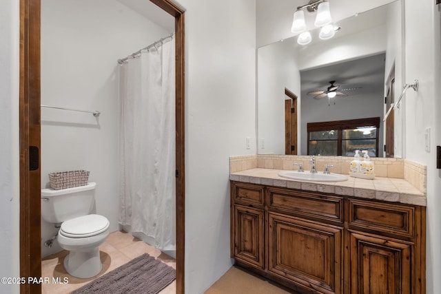 bathroom with tile patterned flooring, vanity, a shower with curtain, toilet, and ceiling fan