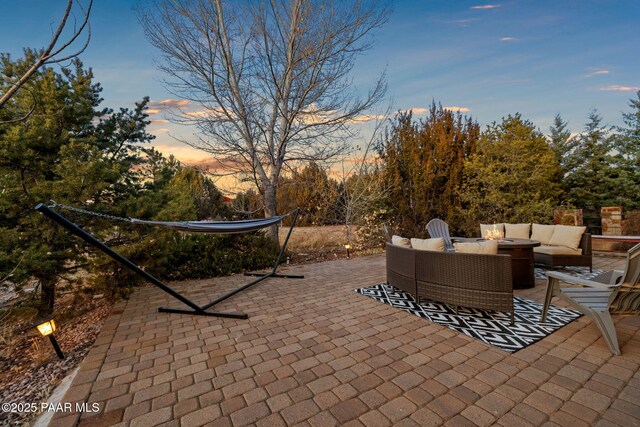 patio terrace at dusk featuring outdoor lounge area