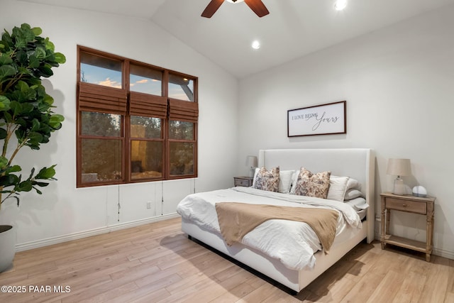 bedroom featuring ceiling fan, light hardwood / wood-style floors, and lofted ceiling