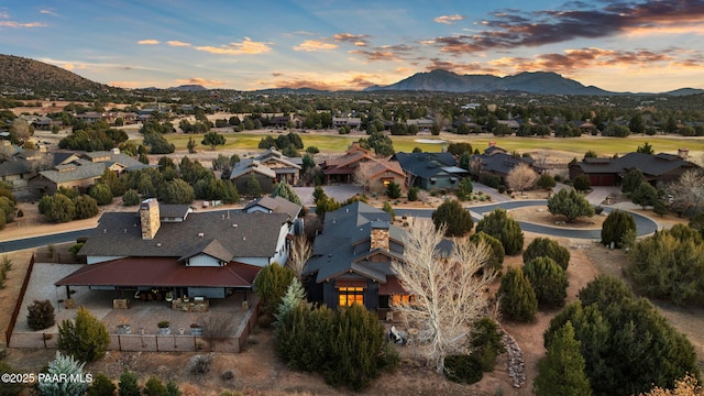 aerial view at dusk featuring a mountain view