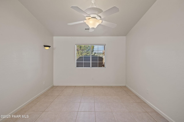 unfurnished room with baseboards, light tile patterned flooring, and a ceiling fan