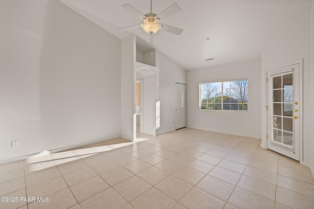 unfurnished room featuring visible vents, arched walkways, light tile patterned flooring, high vaulted ceiling, and a ceiling fan