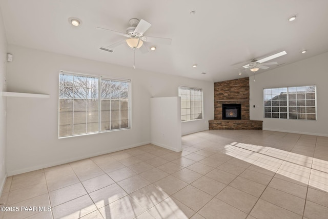 unfurnished living room with tile patterned floors, a healthy amount of sunlight, visible vents, and ceiling fan