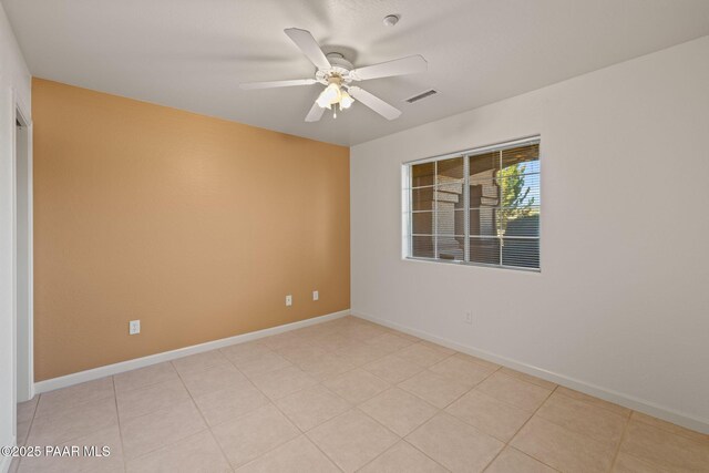 unfurnished room with light tile patterned floors, visible vents, baseboards, and ceiling fan