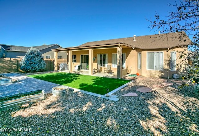 rear view of property featuring a patio area