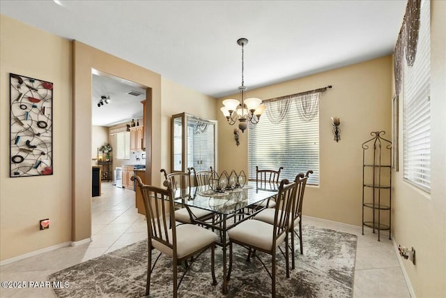 tiled dining area with a wealth of natural light and an inviting chandelier